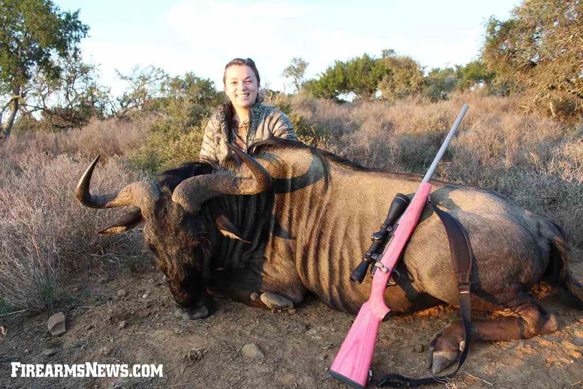 Caroline Boddington with her hot pink 7mm-08 Ruger M77 and a wildebeest.