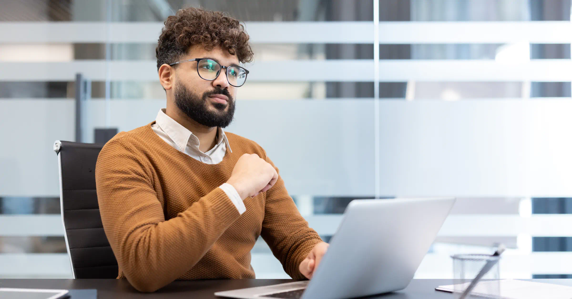 Employee looking disengaged and distracted by workspace friction