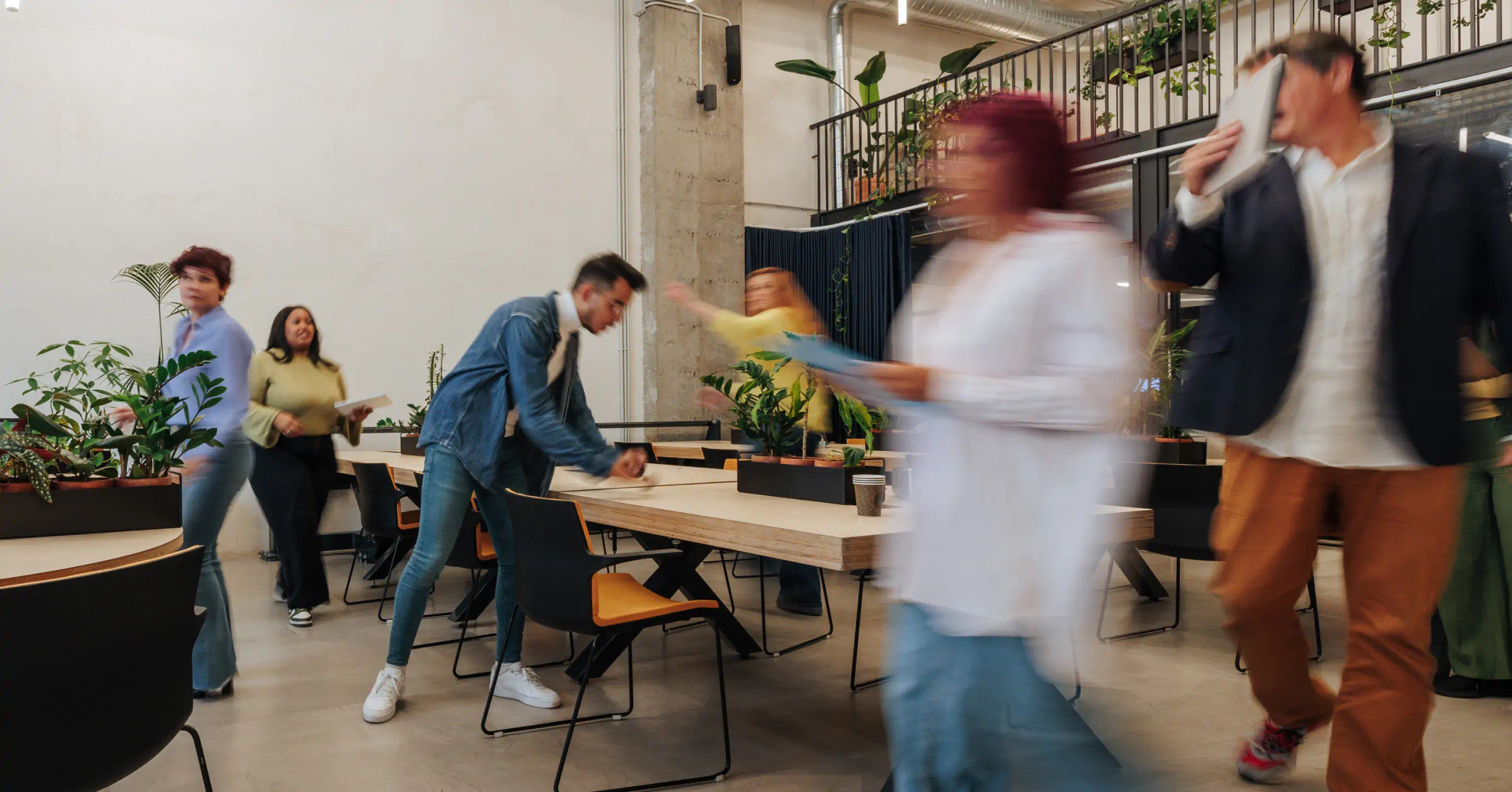 Busy office with employees moving between meetings and activities