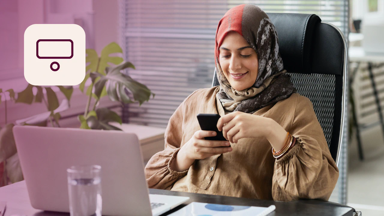 Office employee using her phone to book a desk