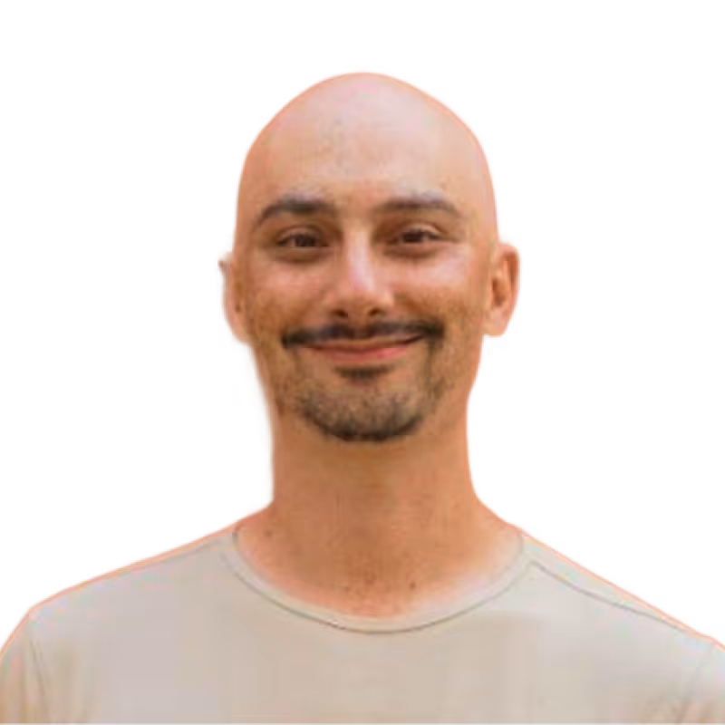 Smiling Zach Epstein wearing a light beige shirt on a transparent background.