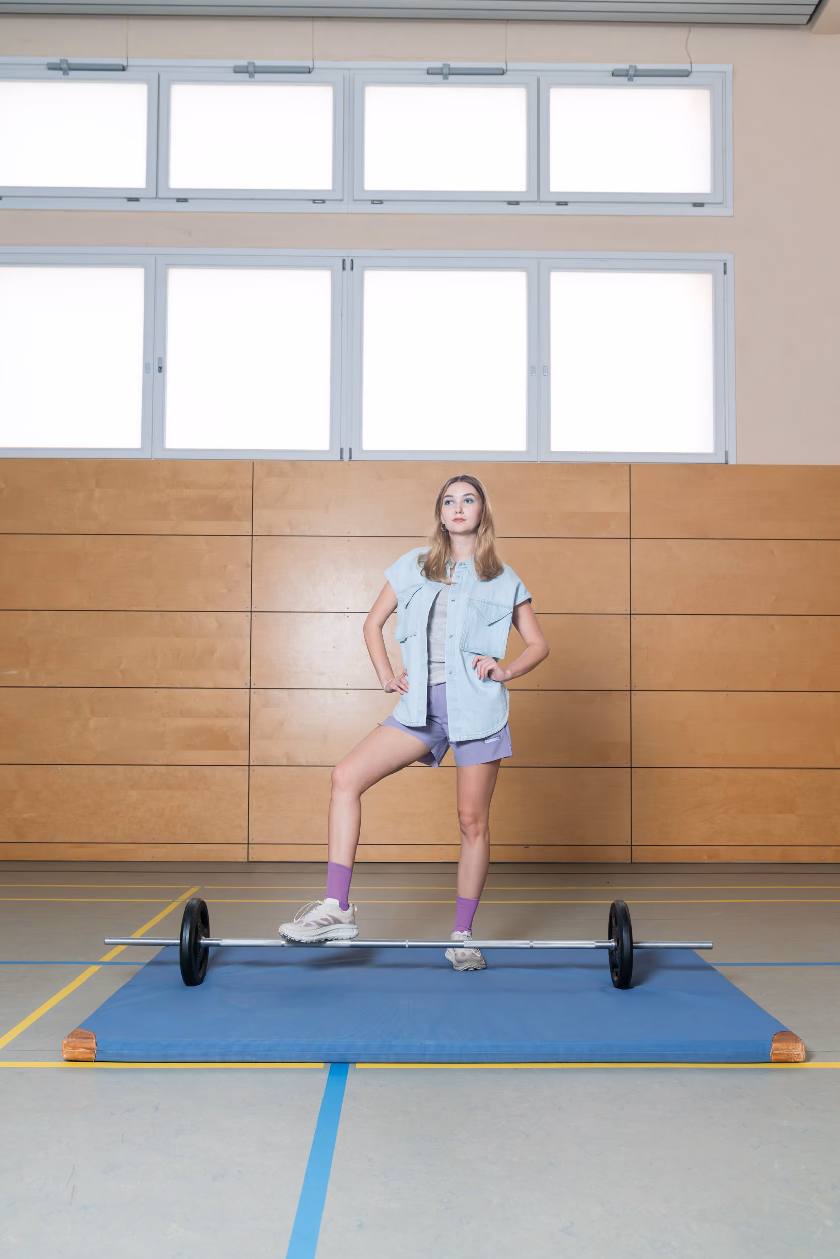 Charlotte wears PeaceShell™ 5" Unlined shorts, HOKA® Mafate Speed 4 Lite STSFY shoes by Satisfy, Teta denim top by Christian Wijnants with the Solio Carmin tank top by Barena Venezia