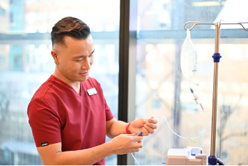 A person in a red shirtDescription automatically generated