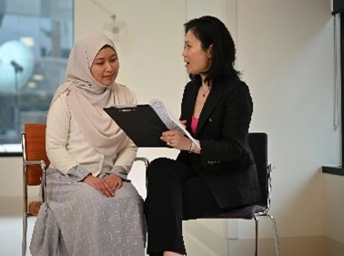 A clinical trial team member discussing a trial with a patient