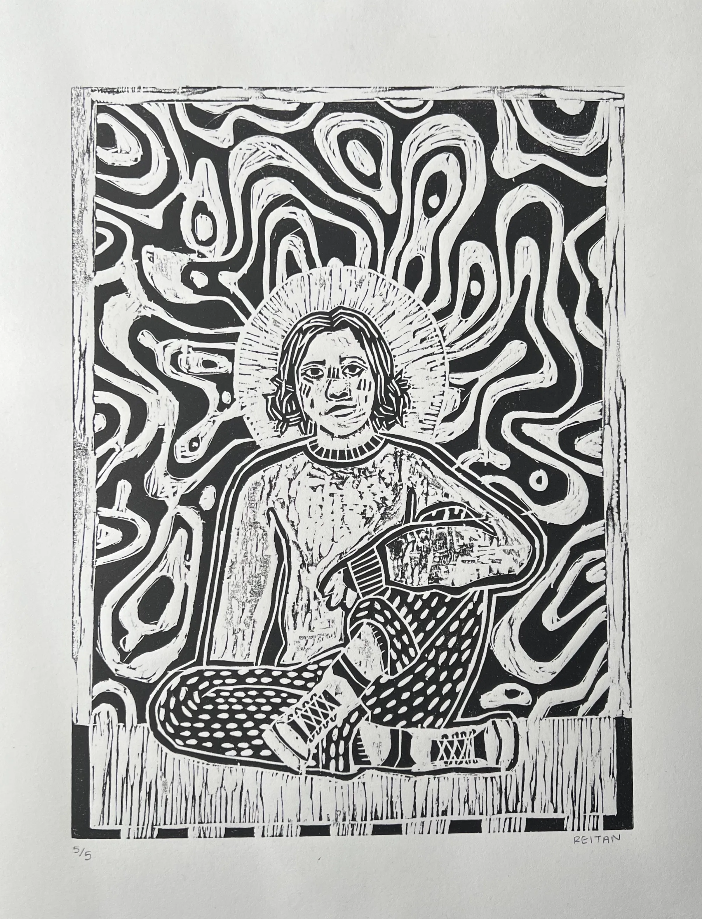 Black and white linocut print of a person sitting cross-legged with a patterned background and a halo around their head.
