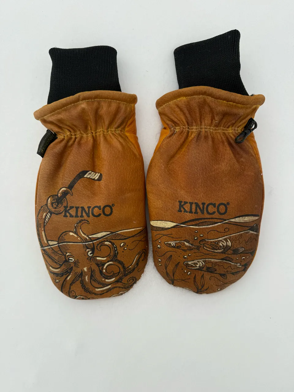 Pair of brown Kinco mittens with black cuffs, featuring underwater illustrations of an octopus and fish.