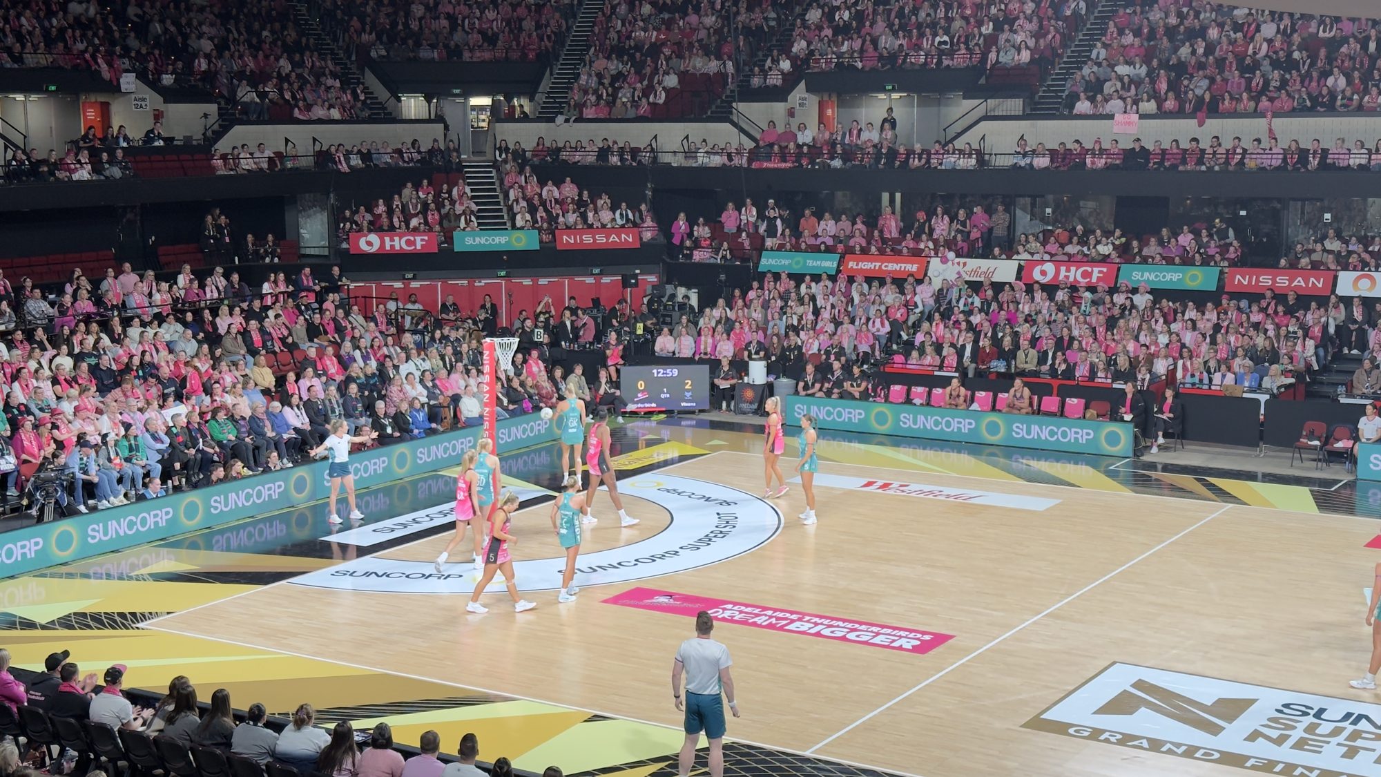 Netball grand final crowd and court with digital signage