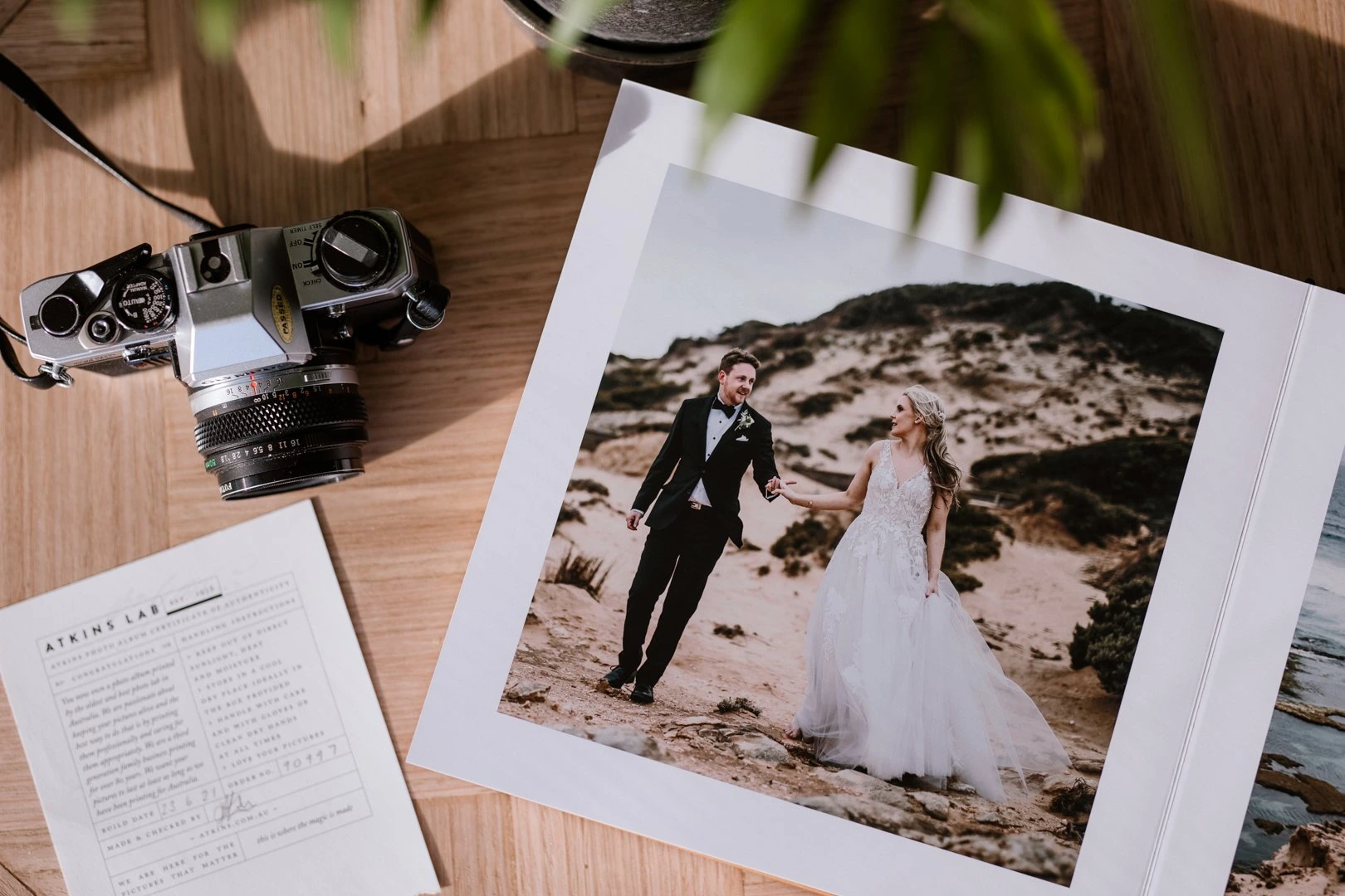 flat lay of a handcrafted wedding album open to a flat lay