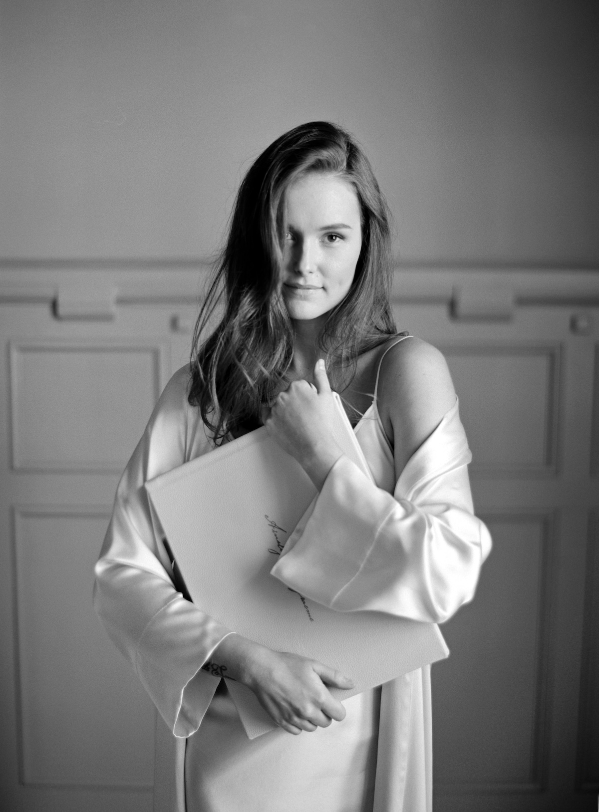 Woman holdinga luxury, hand crafted wedding album