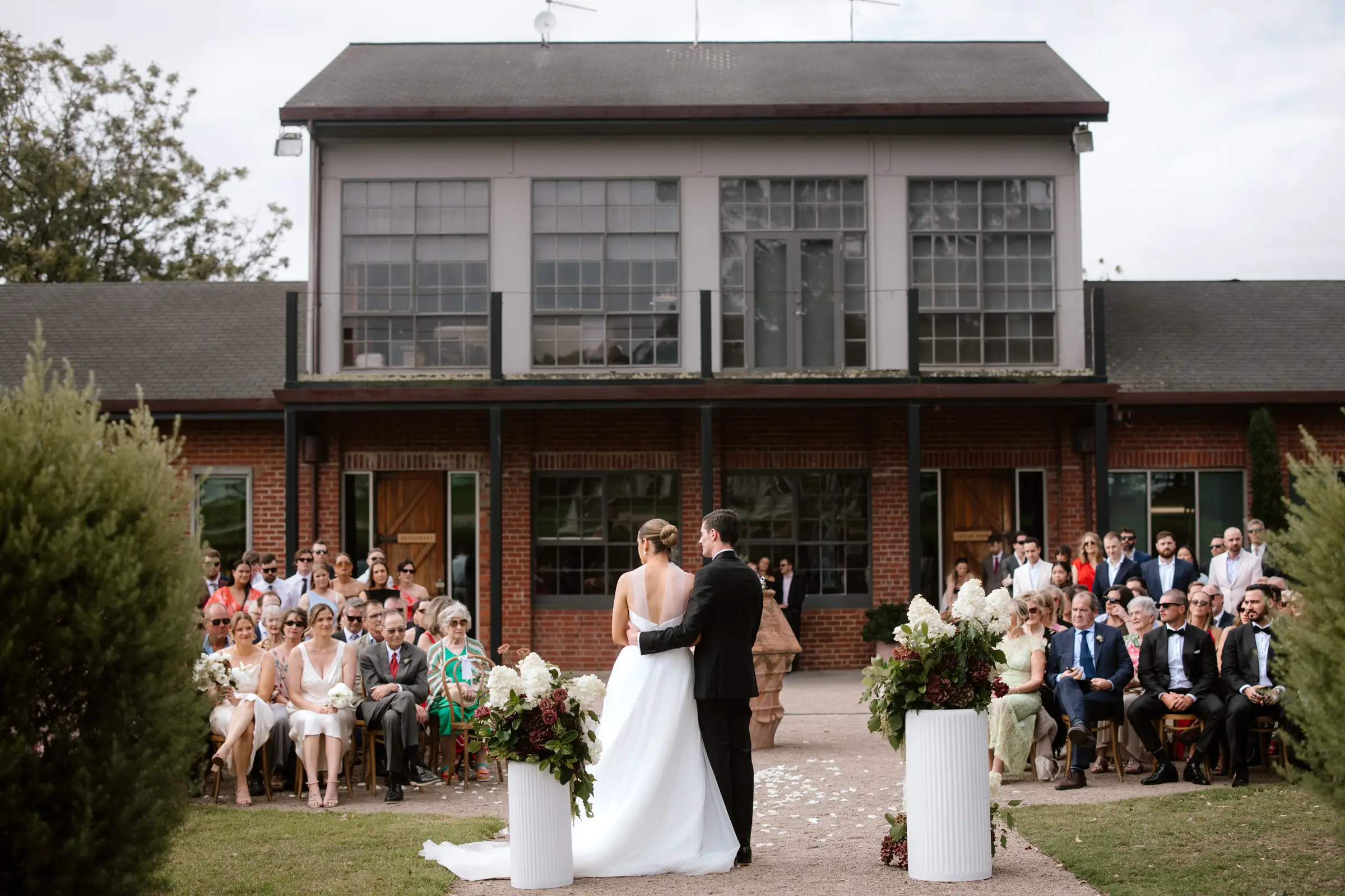 Laughing bride with flower girls in background
