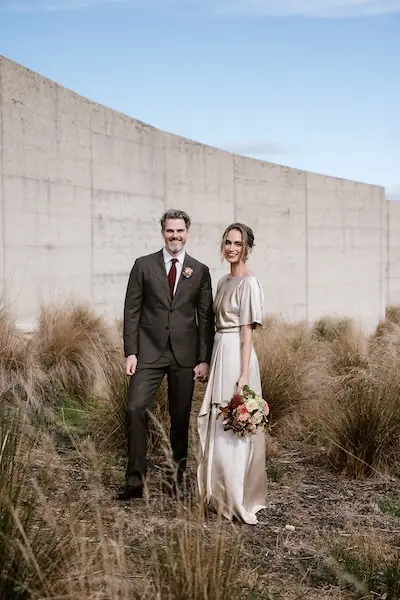 Laura and Rohan posing for a portrait at their vineyard wedding