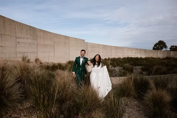 Romantic sunset portrait of newlyweds at their wedding