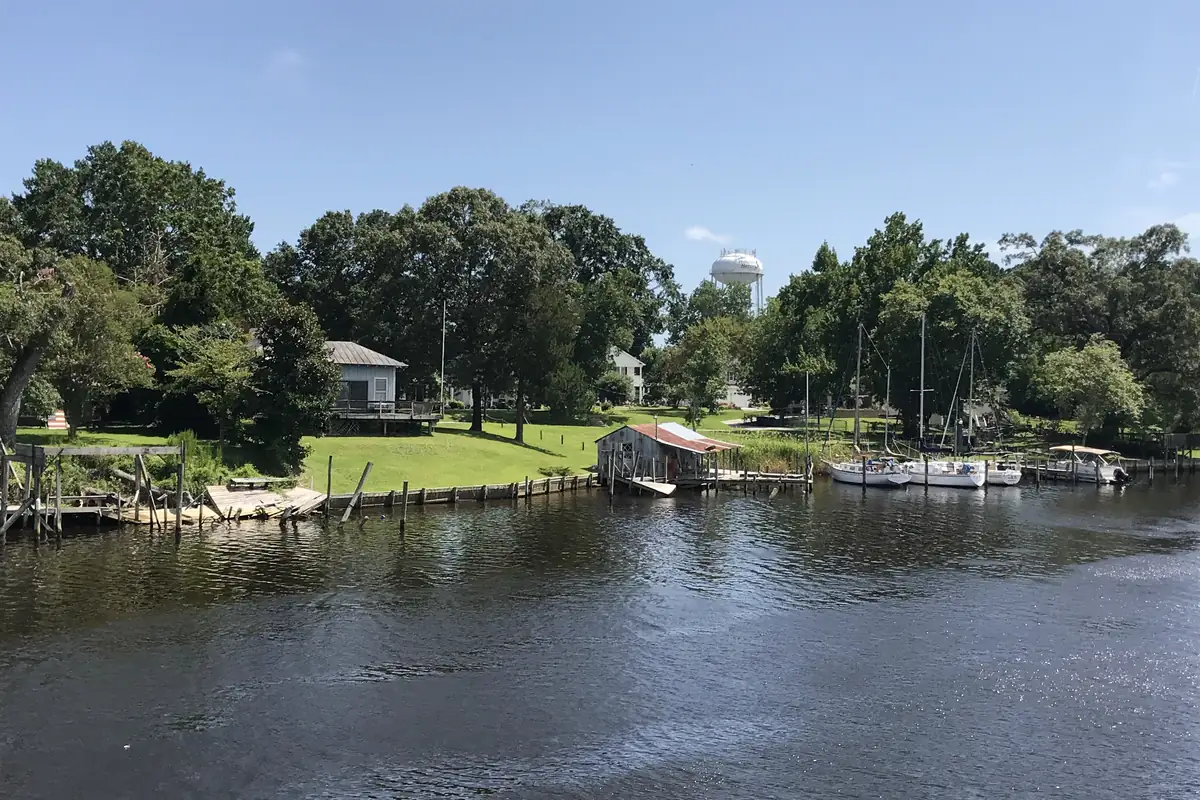 The New River waterfront in Jacksonville, North Carolina, with boats docked along the shore