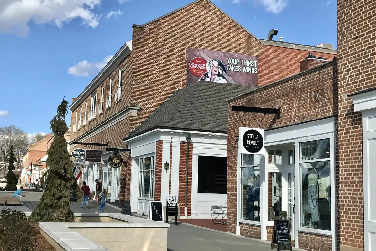 Brick storefronts and a landscaped plaza along West Avenue in downtown Kannapolis, North Carolina