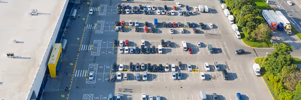 Aerial view of a large parking lot with various vehicles parked