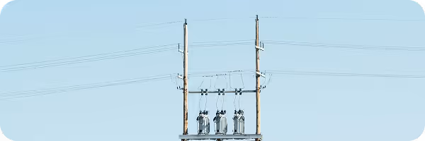 Electrical transmission tower with power lines against clear sky