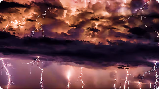 Thunderstorm with lightning bolts illuminating dark clouds, representing extreme weather and energy demand forecasting