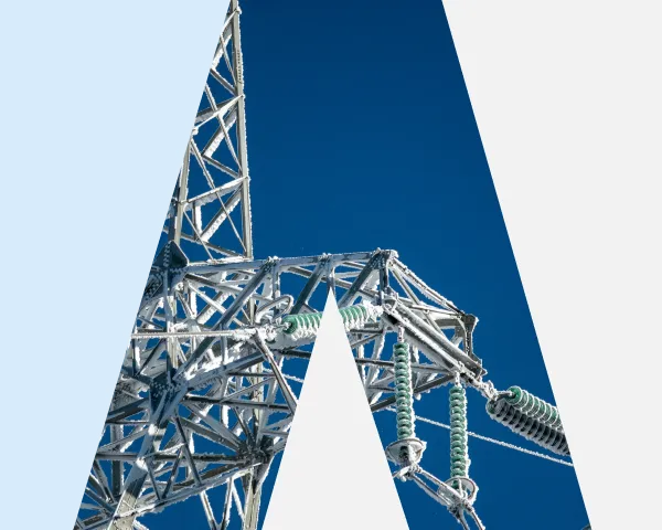 Metal electricity transmission tower against a clear blue sky in the shape of an A.