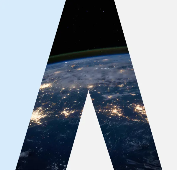 View of Earth's surface at night with city lights, visible from space in a dark sky background.
