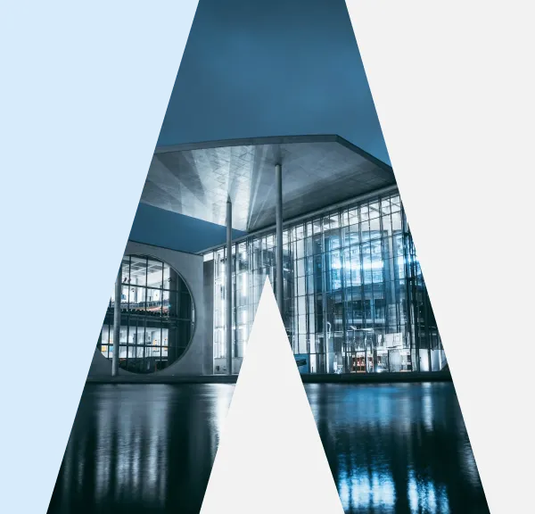 Modern glass building with water reflection, framed by blue and gray shapes forming a large letter A.
