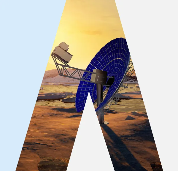 Large blue satellite dish with metal support on a rocky landscape at sunset.