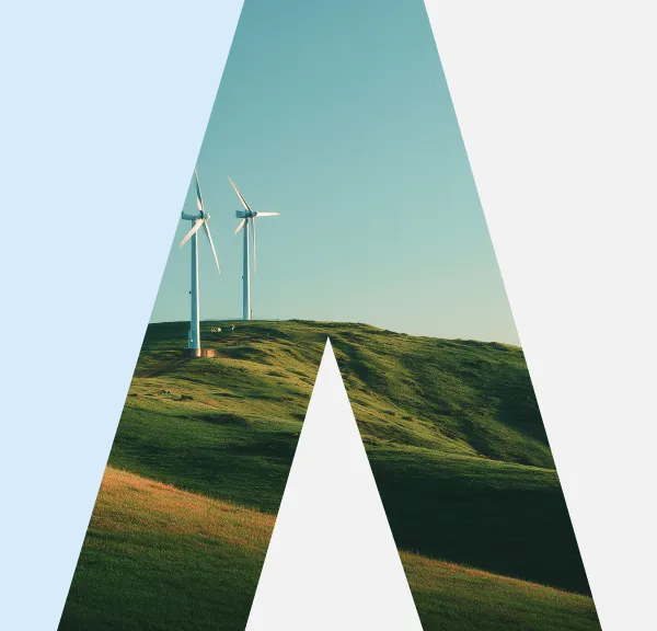 Two wind turbines on green rolling hills beneath a clear blue sky, framed by an abstract triangular shape.