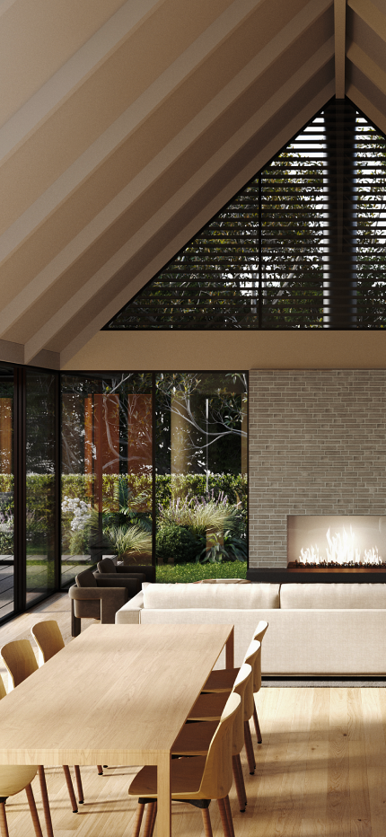 Modern dining room with wooden table and chairs, beige sofa, glass walls showing outdoor greenery, and a lit fireplace against a brick wall beneath a vaulted ceiling.