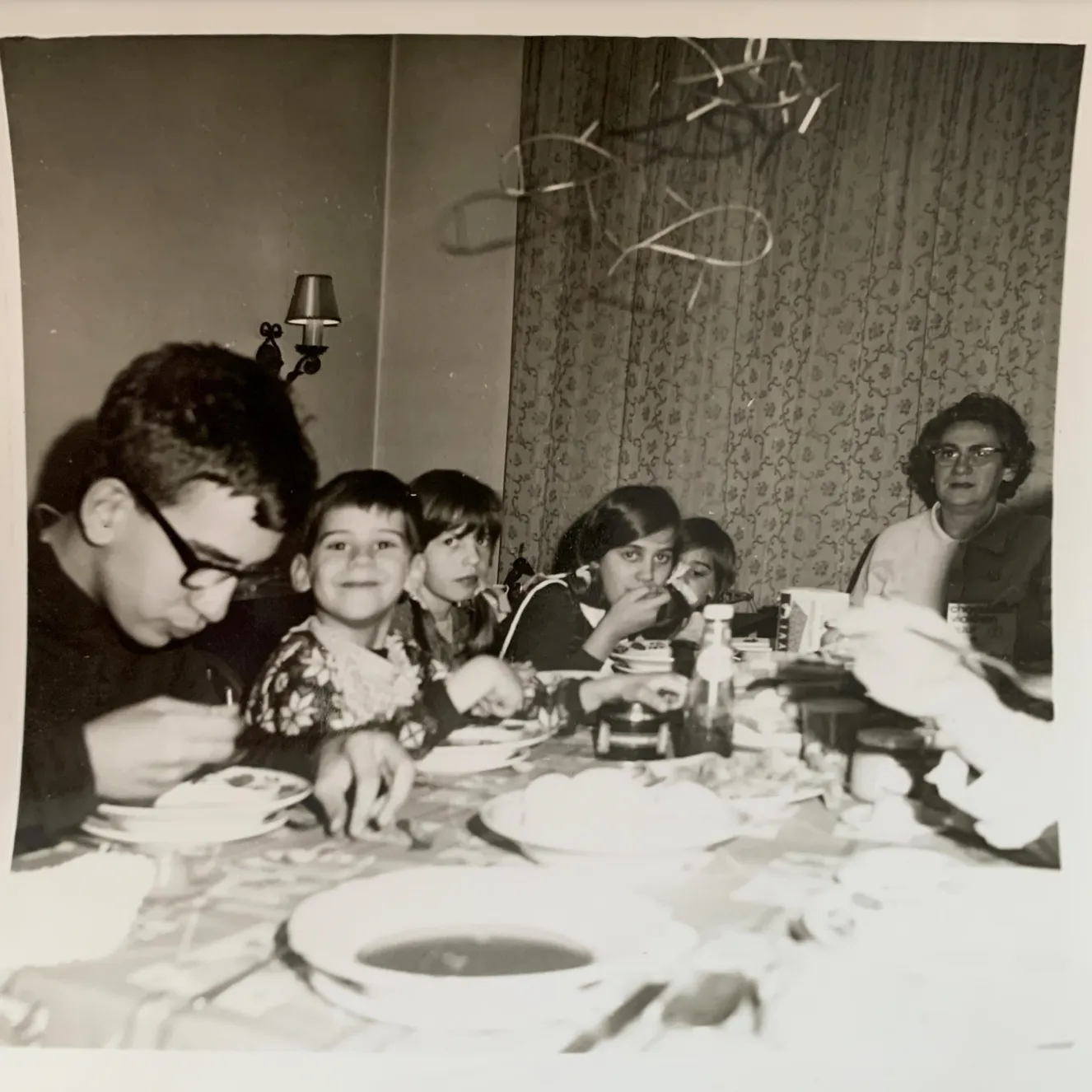 a old picture of Tom with his mom, brothers and sisters
