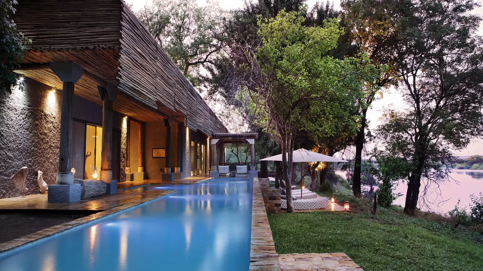 A luxury lap pool overlooks Zambezi River views 