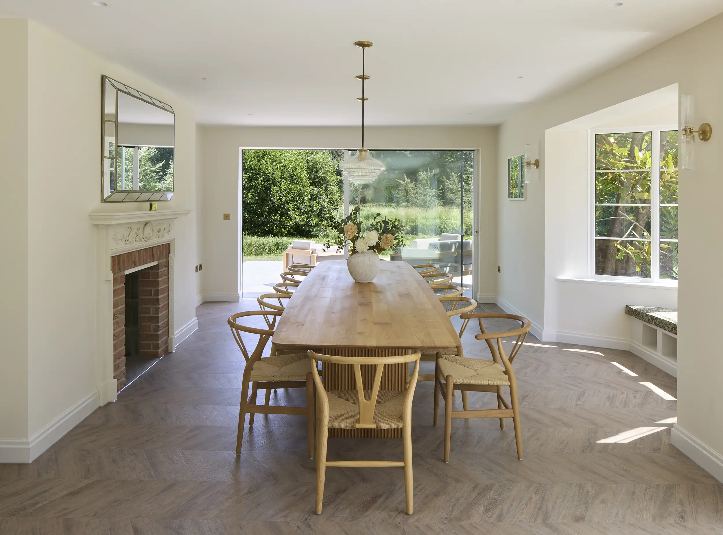 Dining area featuring a 14 place table at Kimbridge House - a luxury farmhouse refurbishment in Hampshire