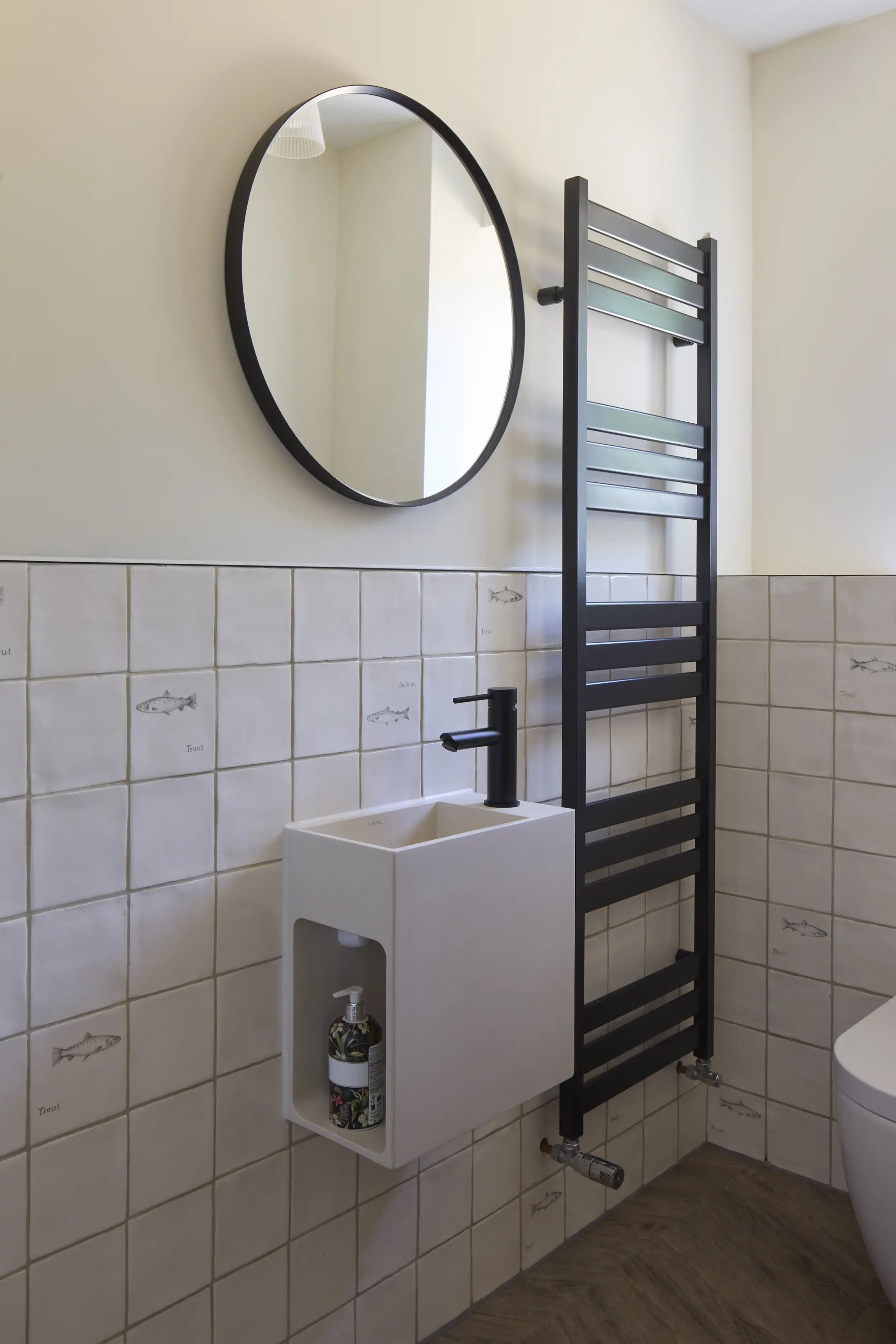 Hand-painted tiles in the WC at Kimbridge House on the Test Valley, Hampshire