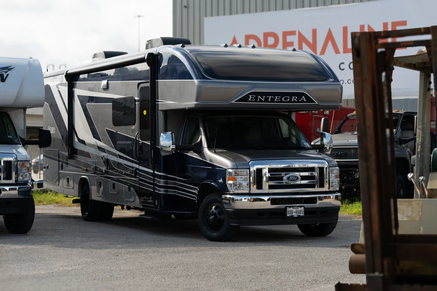Entegra Class C motorhome on Ford E-Series chassis at Adrenaline Offroad Co. shop in Tomball TX for RV suspension lift kit installation