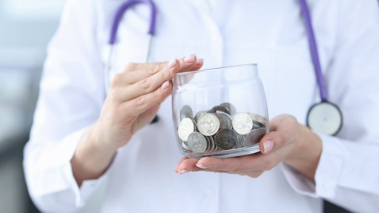 LPN holding a jar of money