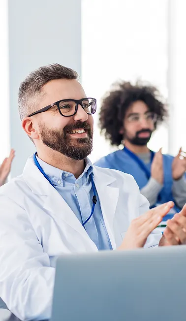 Pharmacist smiling and clapping after successful training completion