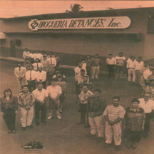 Historic photo of Betances Inc storefront with team members gathered in front
