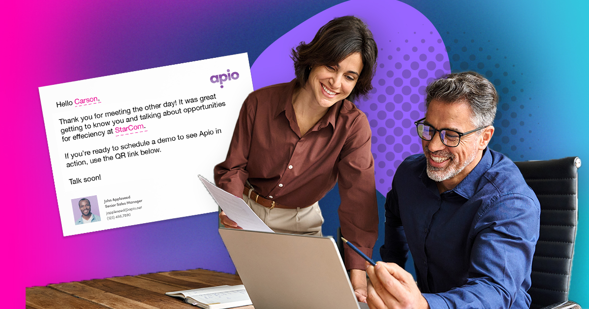 Two office workers in finance look over their plans for a their direct mail campaign using personalization.