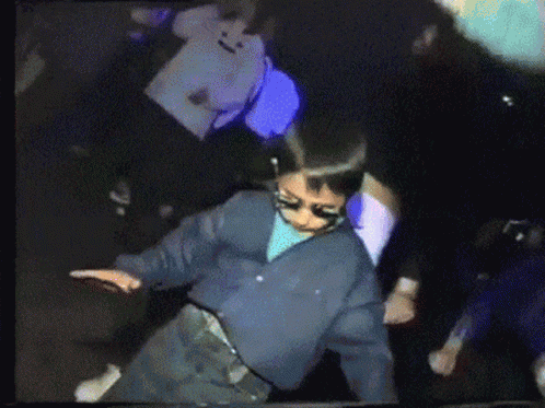 A kid in sunglasses dancing with full confidence