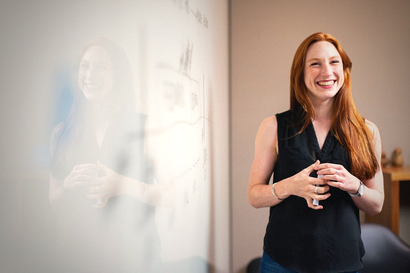A confident presenter mid-laugh