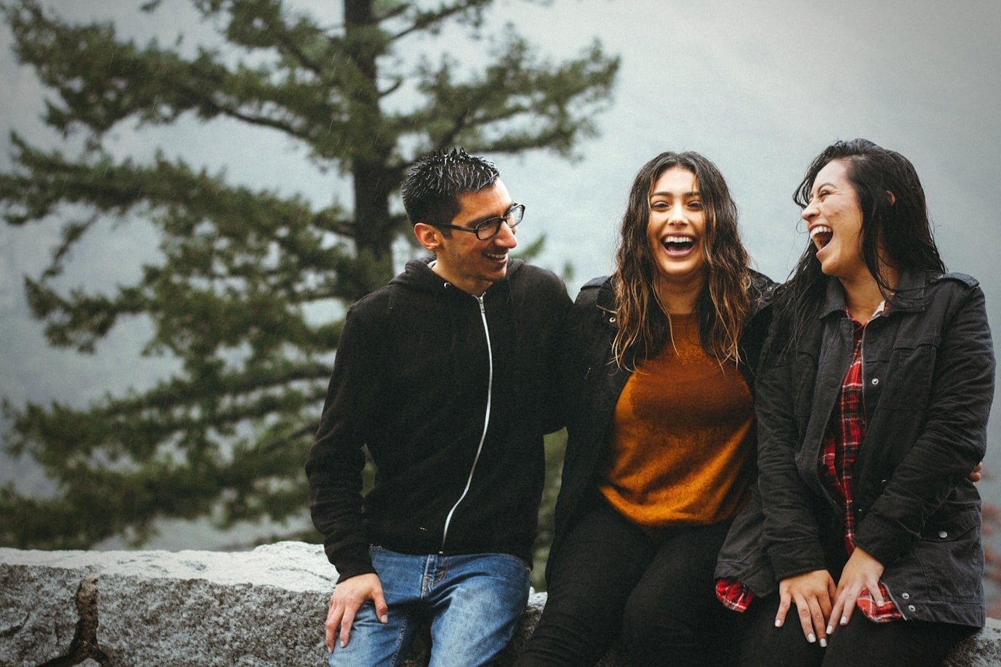 Three people laughing together. Photo by Omar Lopez on Unsplash