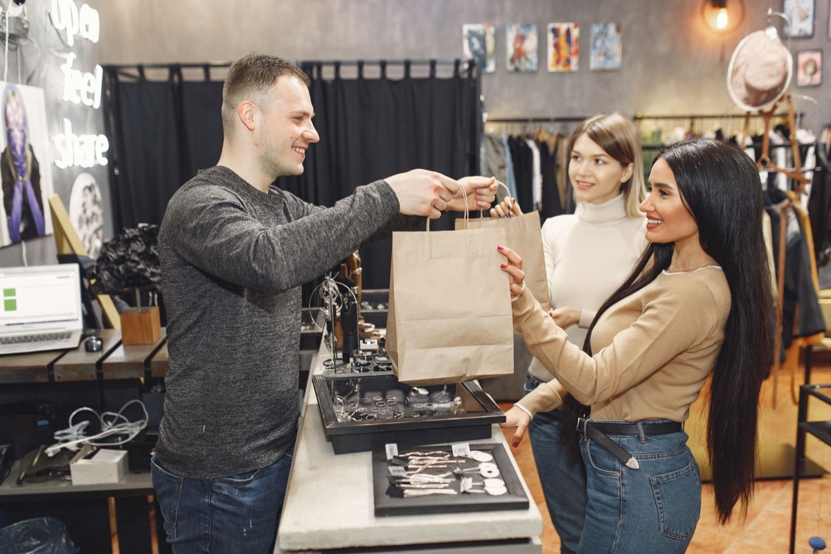 Returning customers picking up a purchase at a store counter