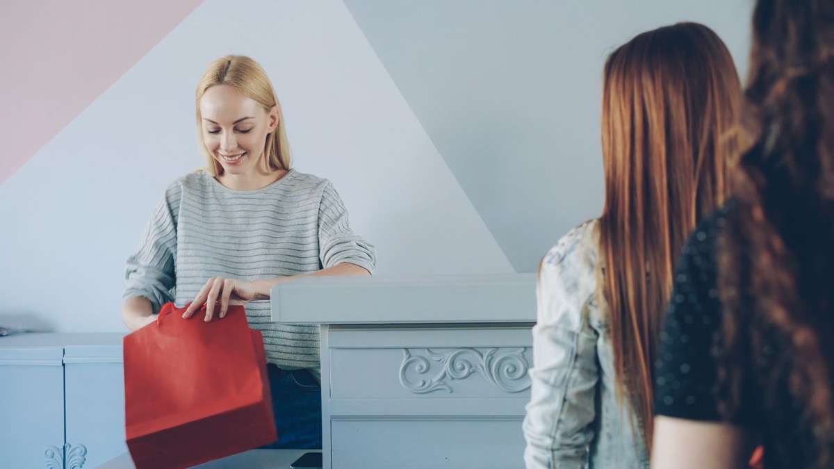 A returning customer collecting a purchase at a store counter
