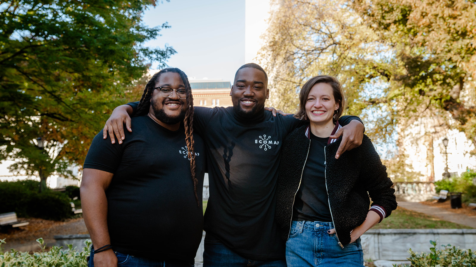 a photo of three coworkers together posing for a photo