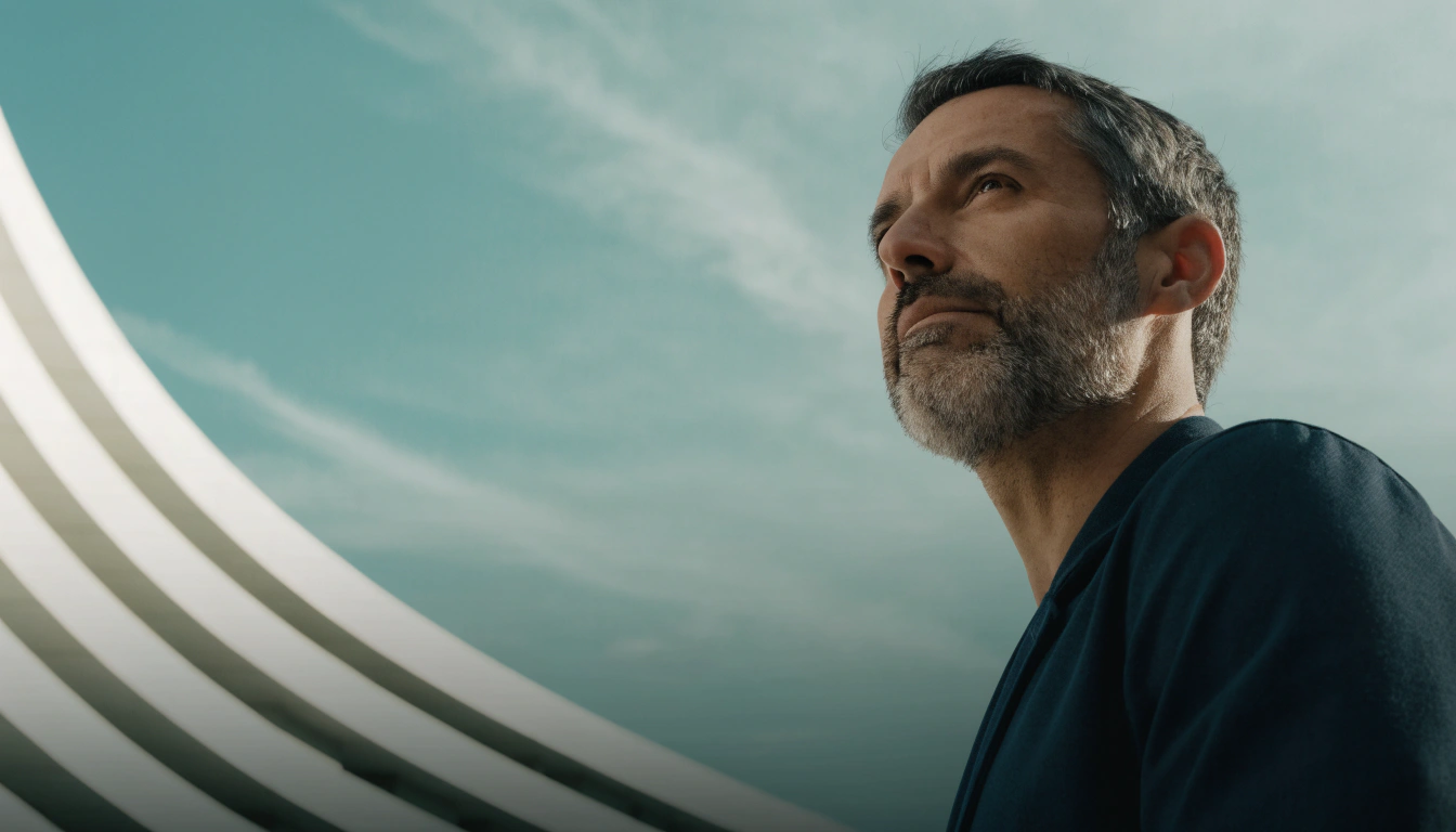 Consultant looking up beside a curved modern building