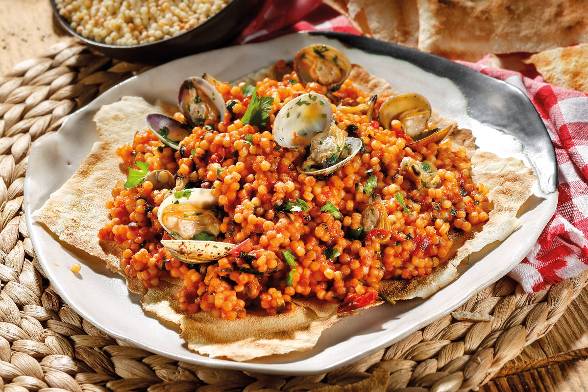 A seafood dish sitting on a plate with the sun shining on it
