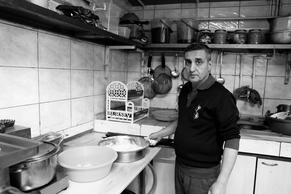 A private chef in a kitchen in black and white