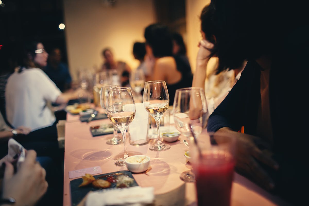 A dinner party with wine glasses on a table