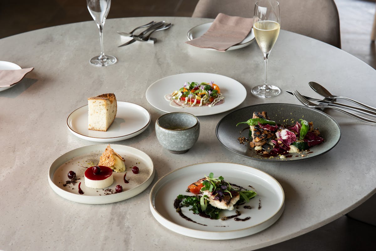 A table set with a bunch of dishes for a private event