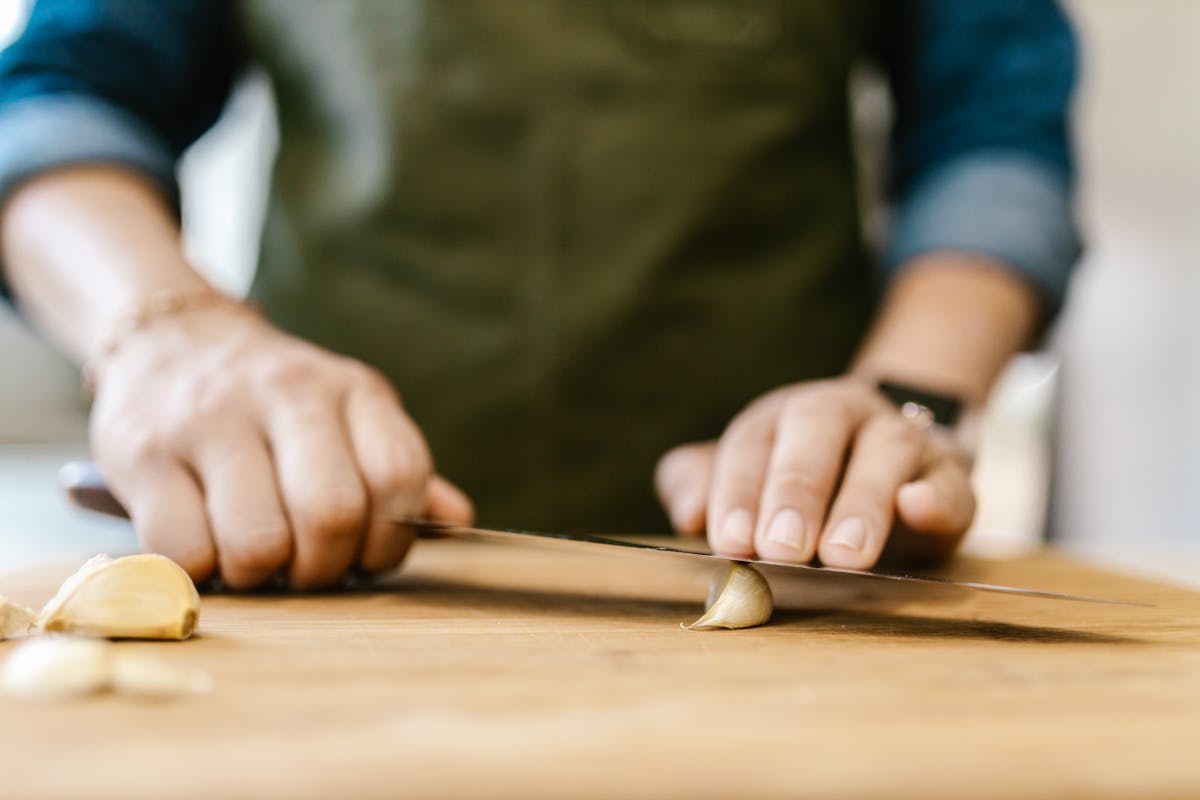 A chef cutting onions on a cutting board