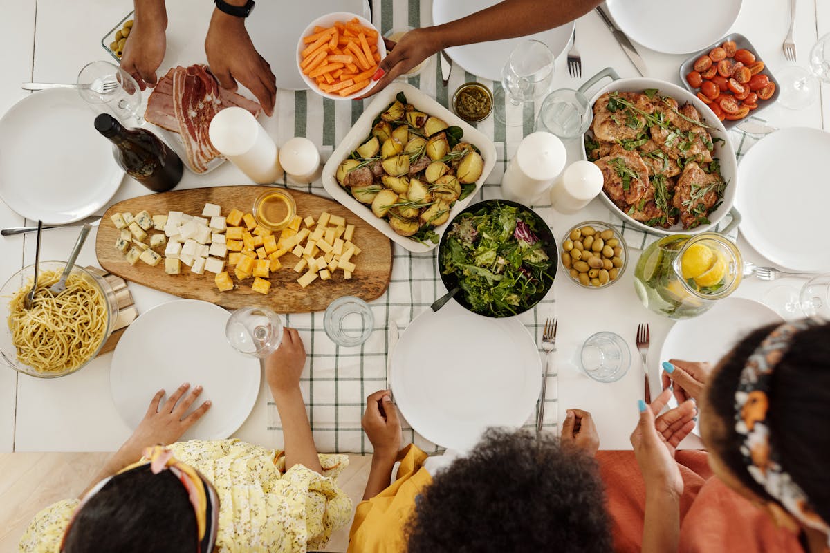 A table at a home full of food with people around it