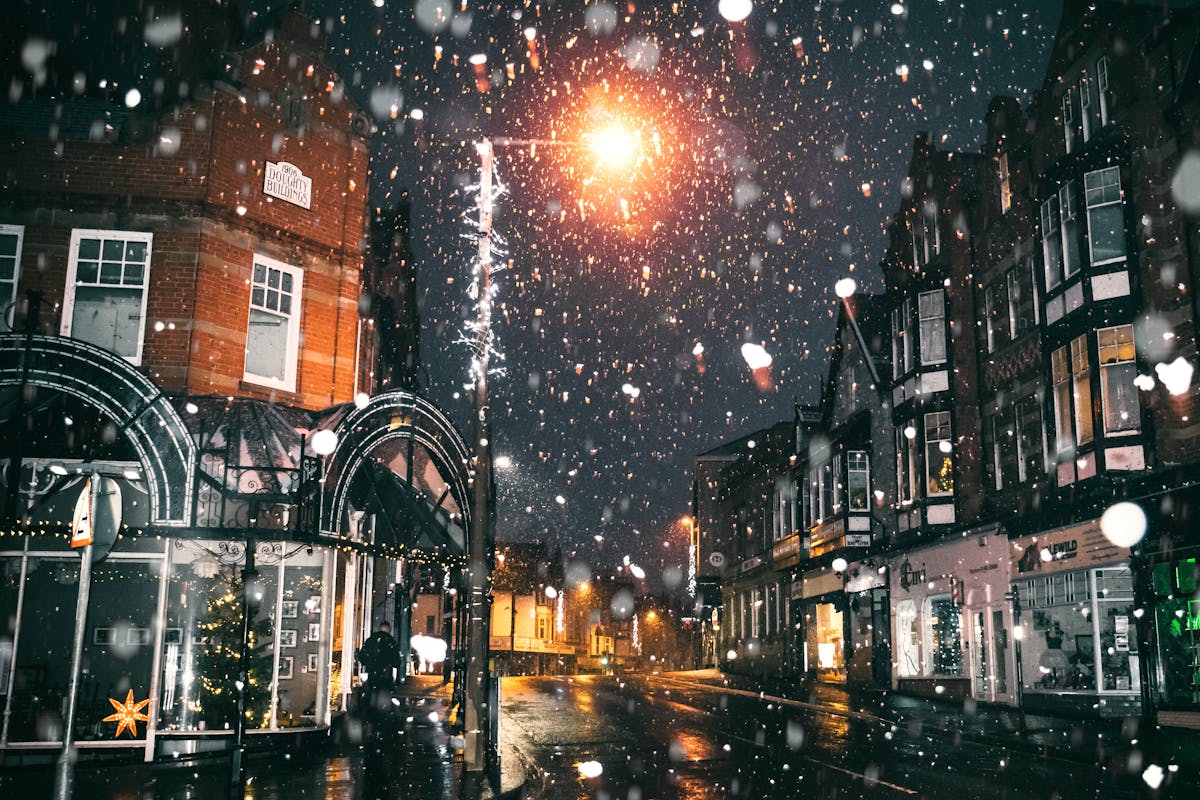 A town with snow falling in front of it